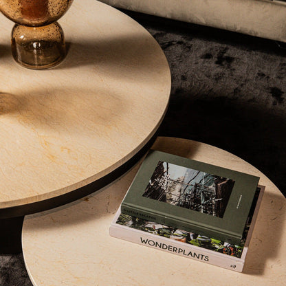 Detail van de Bregt salontafel van PTMD, beige marmeren blad met boek en vaas